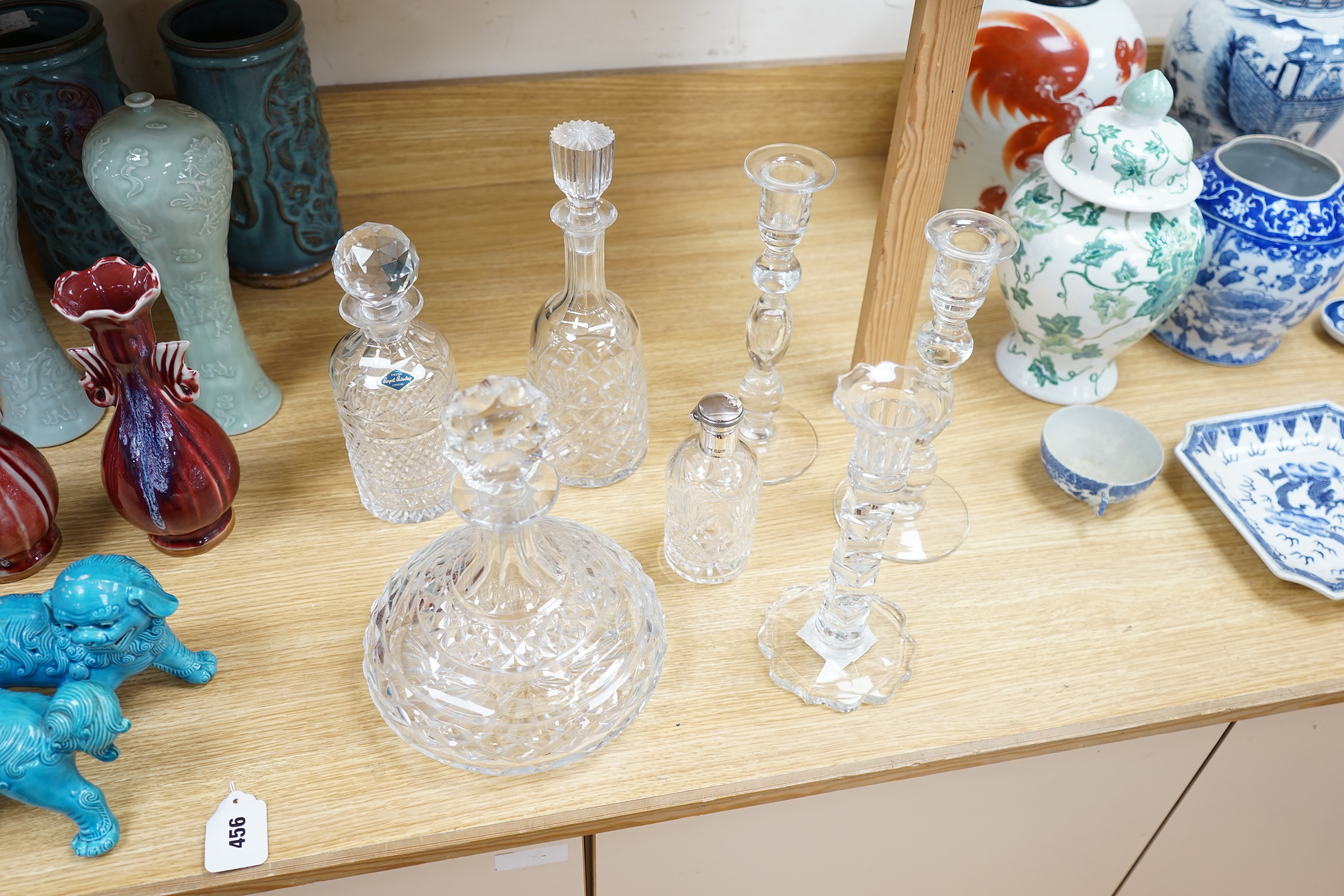 A cut glass ship’s decanter, two others and three various cut glass candle sticks, tallest decanter 30cm high. Condition - good